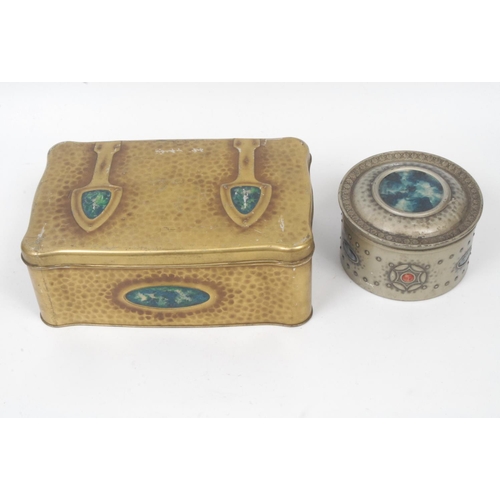 55 - An early 20th century Arts and Crafts shaped rectangular hammered 'copper' tin, with oversized hinge... 