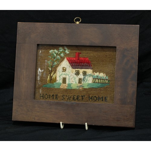 144 - A Victorian woolwork picture of a cottage, Home Sweet Home, 20.5cm x 25.5cm overall