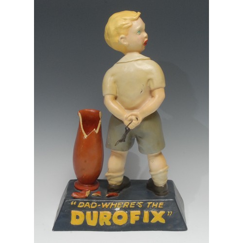 2202 - Advertising – a reproduction Durofix painted composition shop display figure of a boy, he stands wit... 