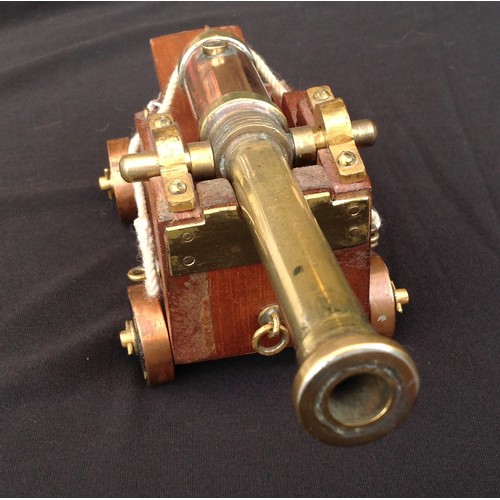 462 - A Trench Art Ships Cannon made from Brass and Copper with a wooden carriage. Barrel length 17cm over... 