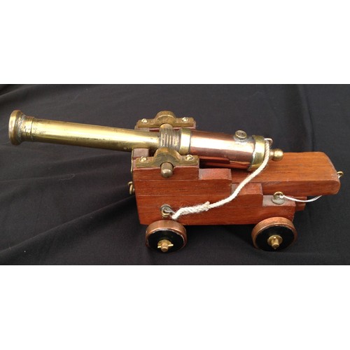 462 - A Trench Art Ships Cannon made from Brass and Copper with a wooden carriage. Barrel length 17cm over... 