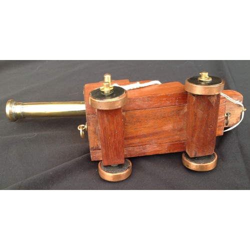 462 - A Trench Art Ships Cannon made from Brass and Copper with a wooden carriage. Barrel length 17cm over... 