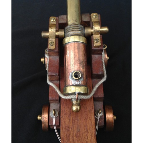 462 - A Trench Art Ships Cannon made from Brass and Copper with a wooden carriage. Barrel length 17cm over... 