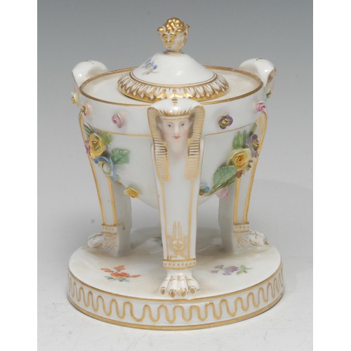 137 - A Meissen tripod inkwell and cover, in the Empire taste, encrusted with flowers, painted with scatte... 