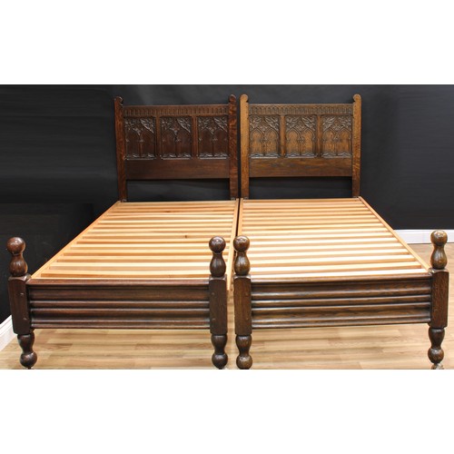 1512 - Frank Pratt of Derby - a pair of 17th century design oak beds, each headboard crested by a nulled fr... 