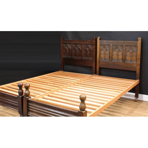 1512 - Frank Pratt of Derby - a pair of 17th century design oak beds, each headboard crested by a nulled fr... 