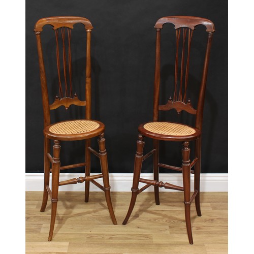 1513 - Frank Pratt of Derby - a pair of Victorian style child's correction chairs, each with a shaped crest... 