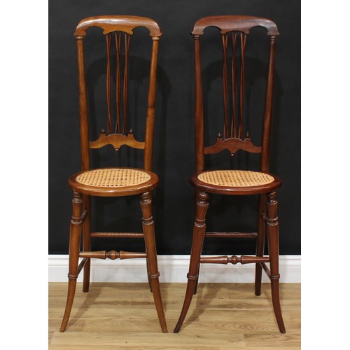 1513 - Frank Pratt of Derby - a pair of Victorian style child's correction chairs, each with a shaped crest... 