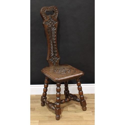 1518 - Frank Pratt of Derby - a Victorian style oak spinning chair, shaped back with pierced handle carved ... 