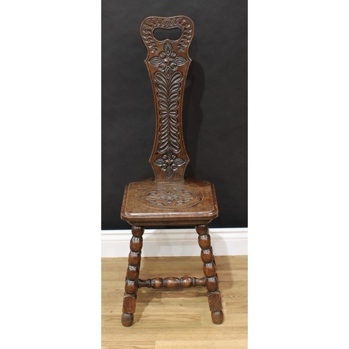 1518 - Frank Pratt of Derby - a Victorian style oak spinning chair, shaped back with pierced handle carved ... 