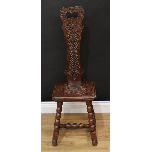 1517 - Frank Pratt of Derby - a Victorian style oak spinning chair, shaped back with pierced handle carved ... 