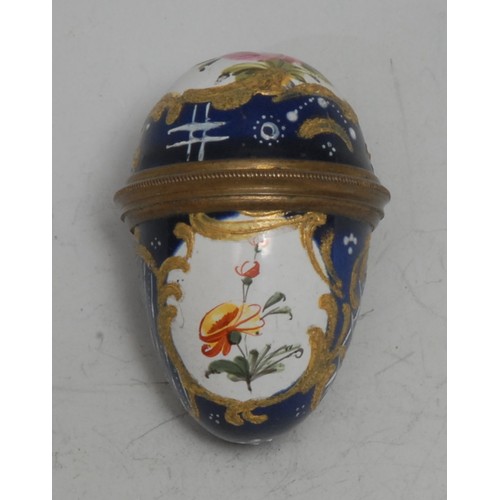 855 - An 18th century South Staffordshire enamel egg shaped bonbonniere, painted with reserves of flowers ... 