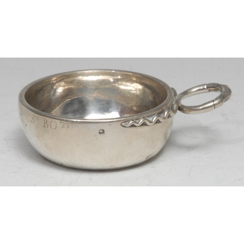 685 - An 18th century French silver wine taster, vine-and-tedril loop handle, 7.5cm diam, 3.5oz