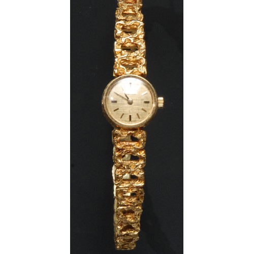 758 - A lady's 18ct gold Omega watch, textured golden dial, baton indicators, integral 18ct gold Omega gra... 