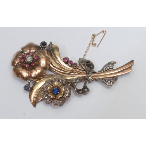 799 - An early 20th century gold plated brooch arranged as a bouquet of summer flowers, the largest flower... 