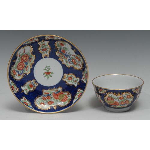 177 - A Barr Worcester tea bowl and saucer, painted in the Kakiemon taste on a scale blue ground, picked o... 