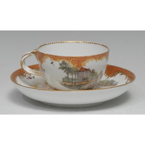 136 - A Meissen teacup and saucer, well-painted with harbour scenes, the sides with scattered sprigs, oran... 