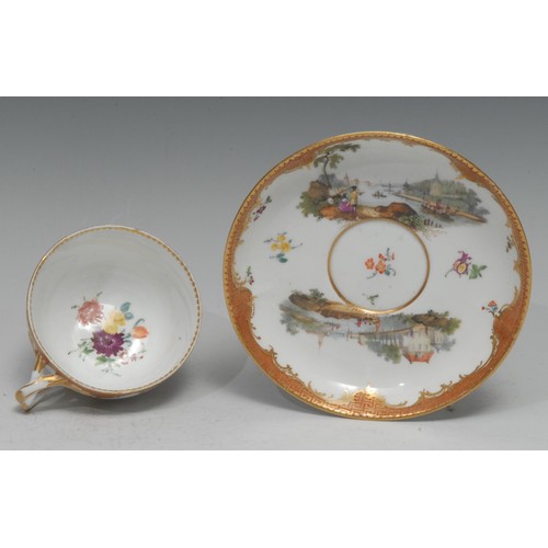 136 - A Meissen teacup and saucer, well-painted with harbour scenes, the sides with scattered sprigs, oran... 