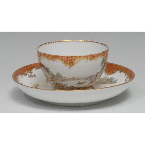 136 - A Meissen teacup and saucer, well-painted with harbour scenes, the sides with scattered sprigs, oran... 