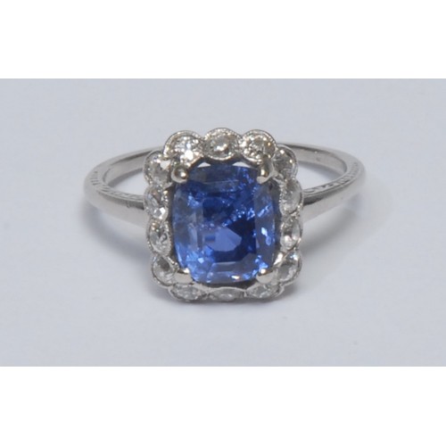 809 - A Sapphire and diamond cluster ring, central octagonal cut mid blue Sri Lankan (Ceylon) sapphire, me... 