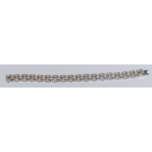 834 - An impressive diamond encrusted arched brick link bracelet, triple row arched link body pave encrust... 