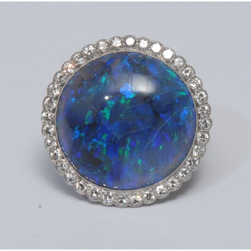 795 - A large black opal and diamond cluster ring, central circular black opal cabochon, measuring approxi... 