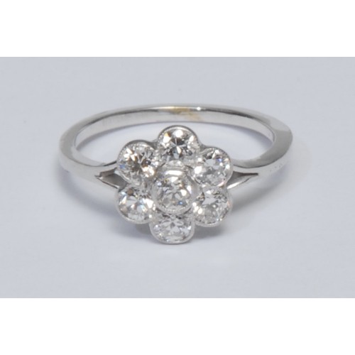 783 - A diamond daisy head cluster ring, central collar set round brilliant cut diamond surrounded by six ... 