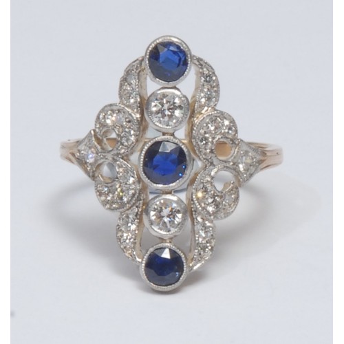 813 - A sapphire and diamond cluster ring, open cast scrolling crest inset with three individually set blu... 