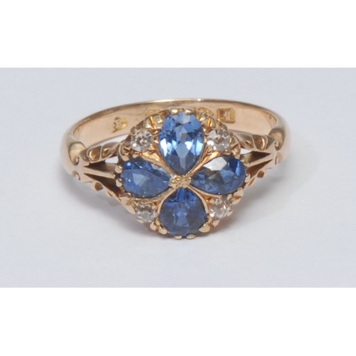 812 - A sapphire and diamond cluster ring, inset with four pale blue pear cut sapphires and four old round... 