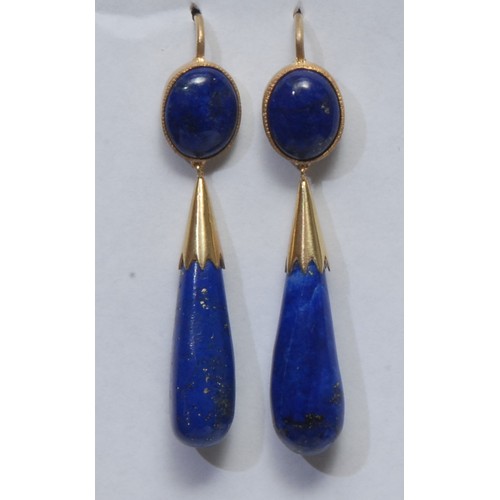 804 - A pair of lapis lasuli torpedo drop earrings, unmarked yellow metal mounts and hook fittings, 46mm d... 