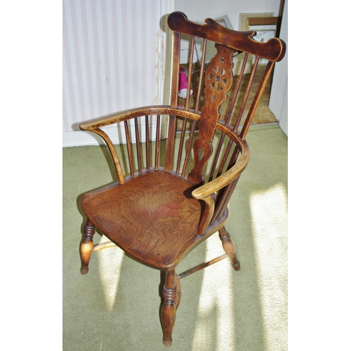 107 - A 19th century elm and ash Windsor elbow chair, shaped cresting rail above a wheel-back splat centre... 