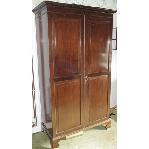 109 - An Edwardian mahogany double wardrobe, dentil cornice above a pair of raised and fielded panelled do... 