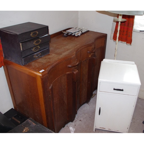 207 - A 1930 oak sideboard;  a wrought iron standard lamp;  white painted bedside cabinet (3)

**Please no... 