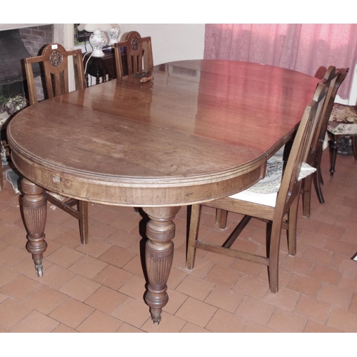 97 - A Victorian walnut rounded rectangular wind-out dining table, moulded top, turned and fluted legs, c... 