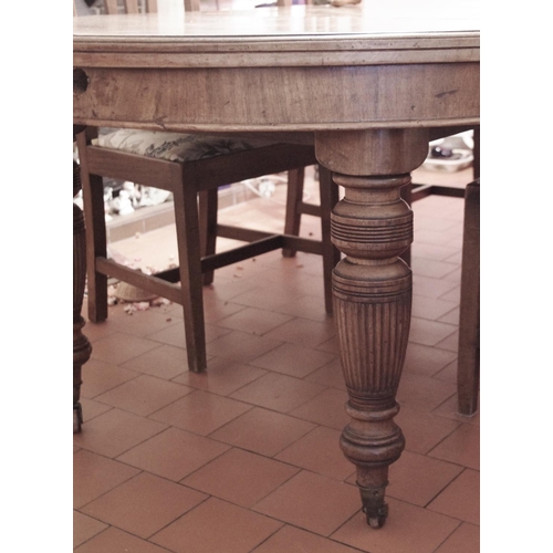 97 - A Victorian walnut rounded rectangular wind-out dining table, moulded top, turned and fluted legs, c... 