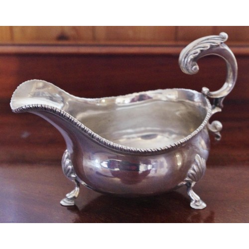 270 - A George III style silver   sauceboat, gadrooned rim, flying acanthus scroll handle, shell and hoof ... 