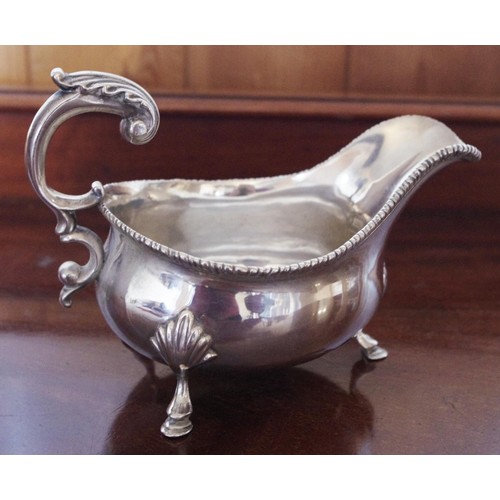 270 - A George III style silver   sauceboat, gadrooned rim, flying acanthus scroll handle, shell and hoof ... 