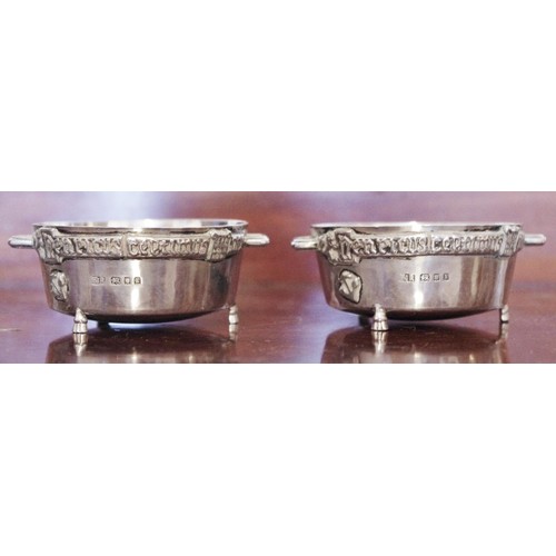 277 - A pair of silver Celtic salt cellars, applied with band of Latin script, FJR, London 1925