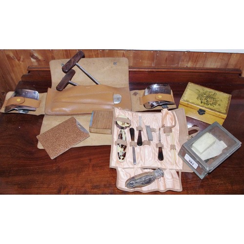 281 - A set of boot pulls and  shoe horn, pigskin folding case;  folding manicure set;  etc

**Please note... 