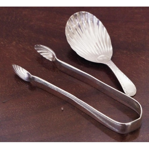 283 - A 19th century caddy spoon, shell bowl;  a set of 19th century silver sugar bows