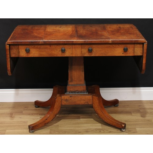 1557 - A George IV mahogany and ebony cross-banded sofa table, canted rectangular top with fall leaves, rec... 