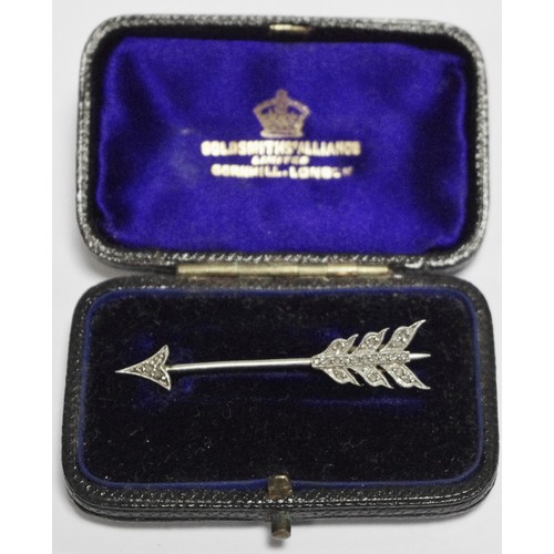 326 - A diamond set gold coloured metal arrow shaped stick pin, with detachable feathered flight