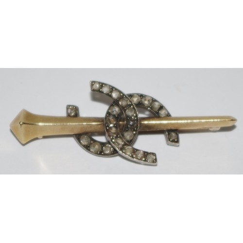 327 - An Edwardian diamond set intertwinded horseshoe bar brooch, set with old cut stones, formed around a... 