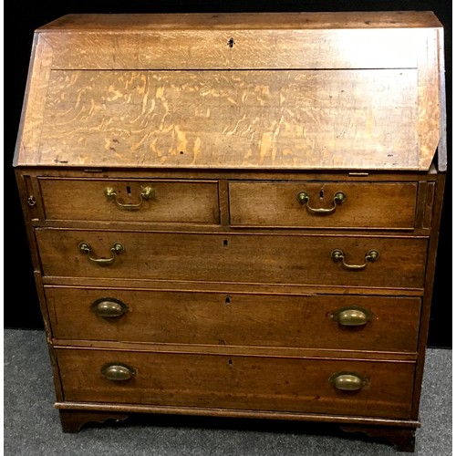 97 - A George III oak bureau, fall front enclosing fitted interior with secret storage, two short cockbea... 