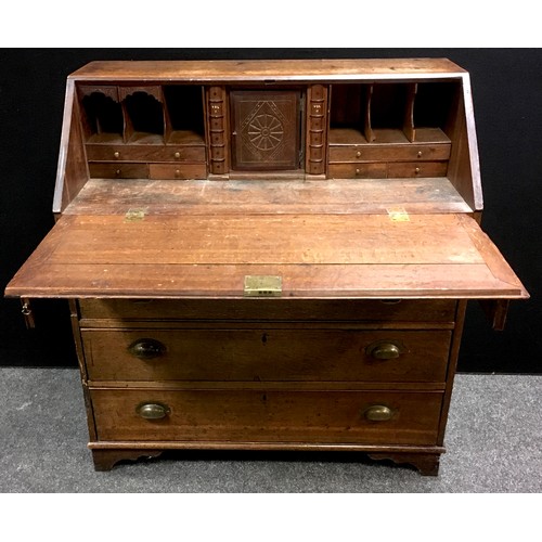 97 - A George III oak bureau, fall front enclosing fitted interior with secret storage, two short cockbea... 