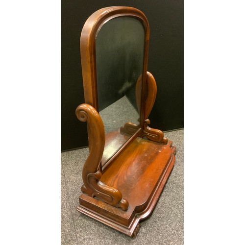 103 - A Victorian mahogany arched top rectangular toilet mirror, shaped scrolling arms, rounded rectangula... 