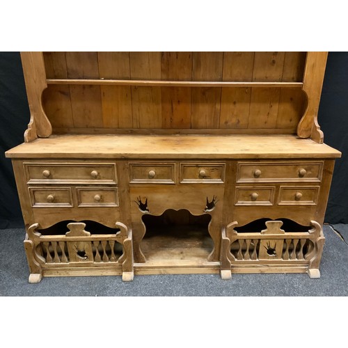 104 - A 20th century French style pine kitchen dresser, swallow cut two shelf back above deep base fitted ... 