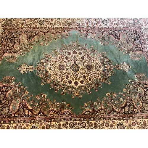 105 - A Super Keshan carpet, central floral medallion within pale green ground,  scrolling corner field al... 