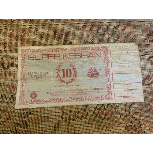 105 - A Super Keshan carpet, central floral medallion within pale green ground,  scrolling corner field al... 