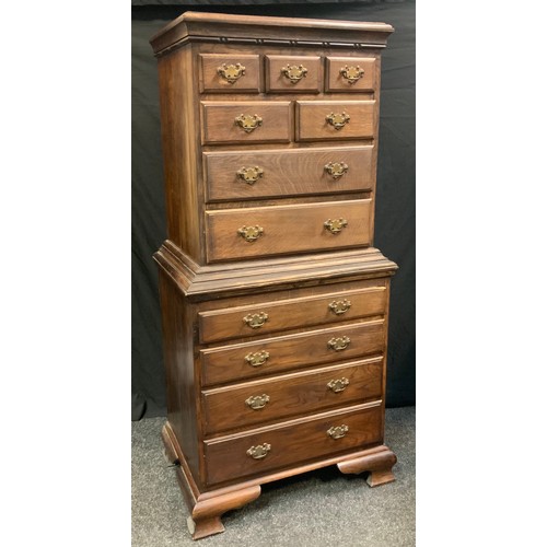 129 - A mid 20th century oak tall boy chest on chest, seven drawer top section above four graduated drawer... 